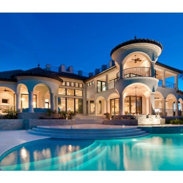 Night view of rear of house overlooking pool